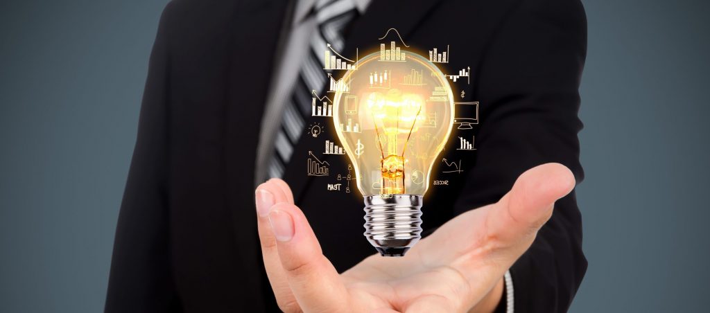 Business man holding light bulb with data icons